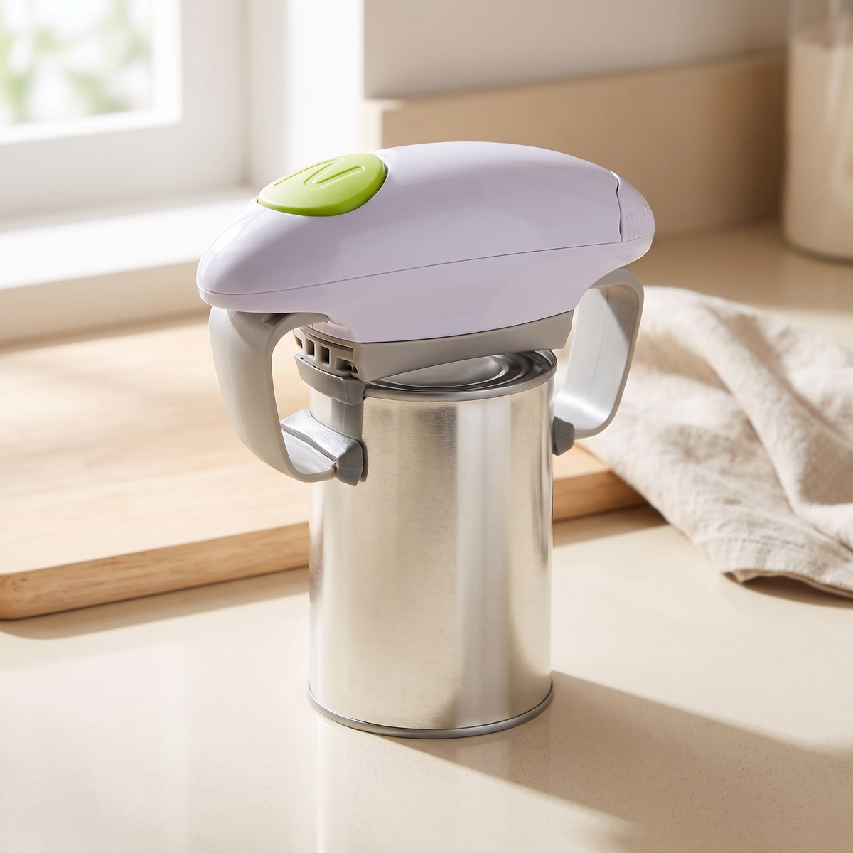 The One-Touch Electric Opener cutting the lid from a steel tin on a kitchen benchtop